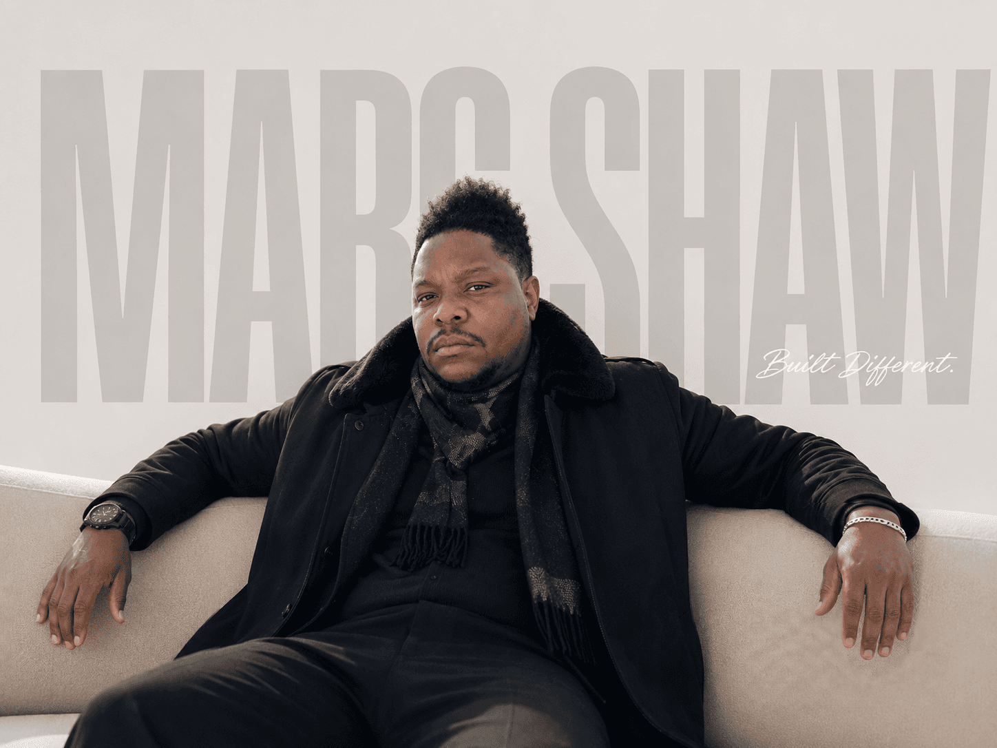 Marc Shaw seated in a black fur-collared coat beneath the Marc Shaw wordmark